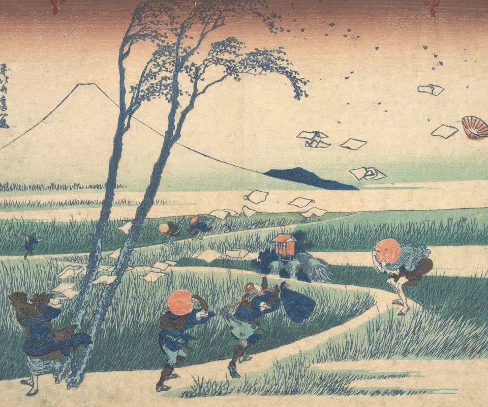 Detail of Ejiri in Suruga Province (Sunshū Ejiri), from the series Thirty-six Views of Mount Fuji (Fugaku sanjūrokkei) by Katsushika Hokusai. Wind scatters papers as travellers struggle along a path near Mount Fuji.