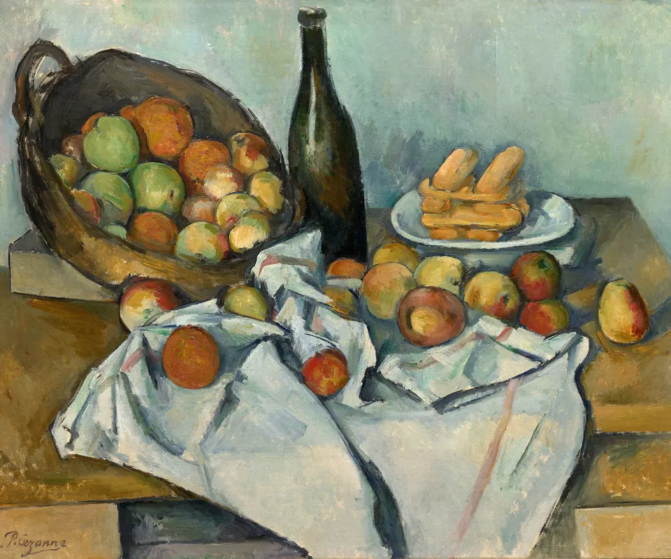 Detail of The Basket of Apples by Paul Cezanne. Apples, a bottle, and biscuits rest on a tilted table with a white cloth.