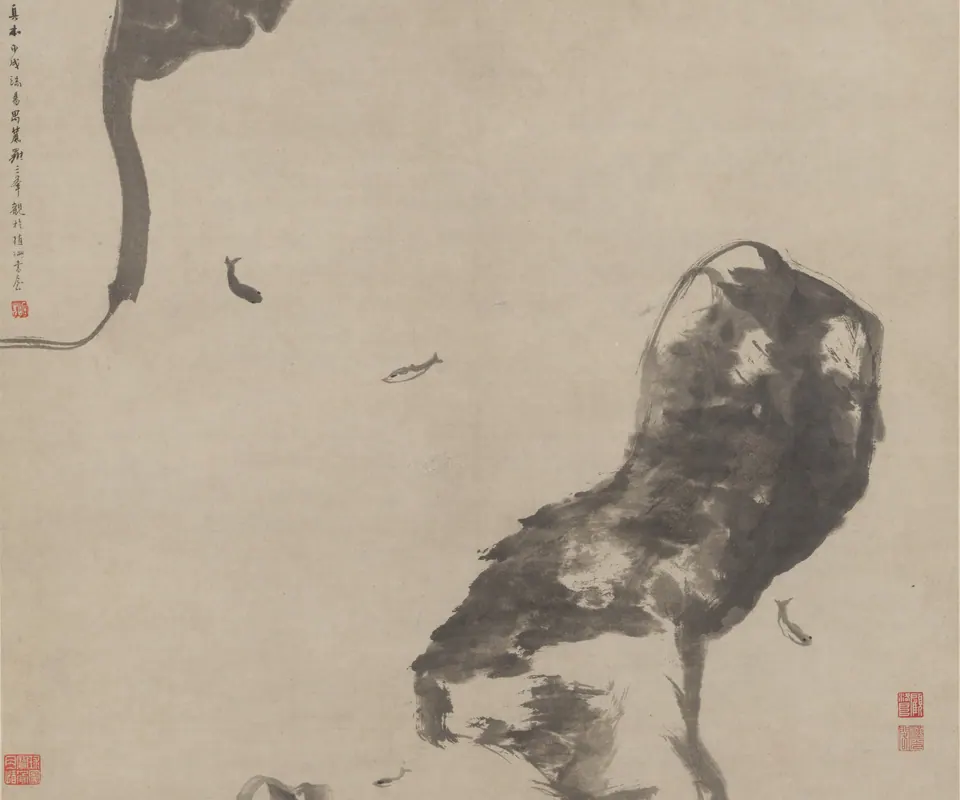 Detail of Fish and rocks by Bada Shanren (Zhu Da). Small fish swim between two large rock forms in a spare ink painting.